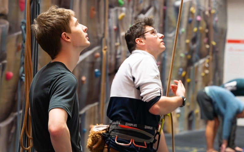 Climbers and belayers together beside the climbing walls