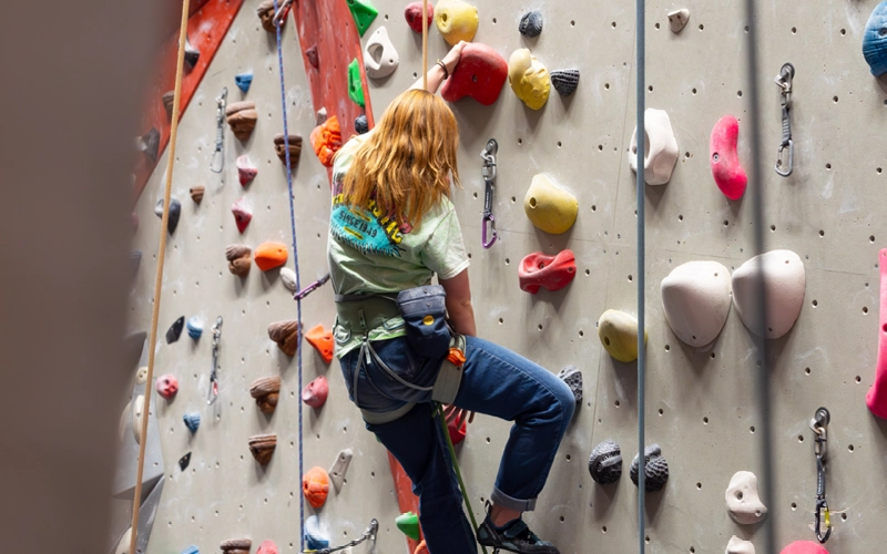 Climber moving up an indoor wall