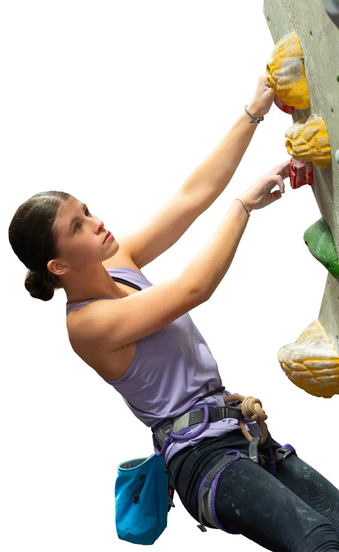 Climber reaching for a hold on an indoor wall